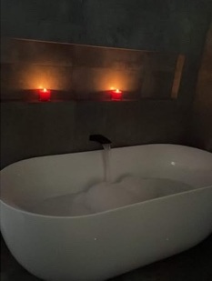 Freestanding bath with wall-mounted tapware